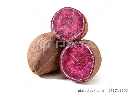 whole raw purple sweet potatoes on background whole raw purple sweet potatoes on background 141711392