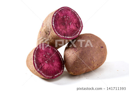 whole raw purple sweet potatoes on background whole raw purple sweet potatoes on background 141711393