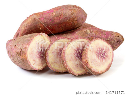 raw purple flesh sweet potato whole and cross section raw purple flesh sweet potato whole and cross section 141711571
