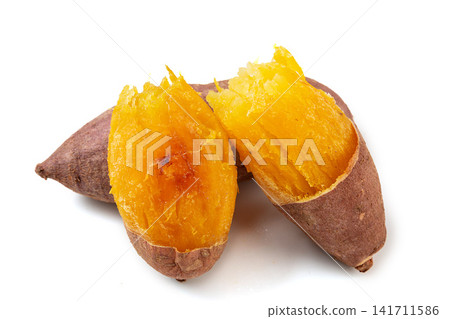 roasted yellow sweet potato broken open on plate 141711586