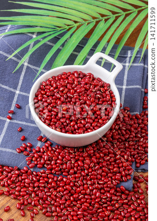 raw organic red adzuki beans filled in ceramic bowls 141711599