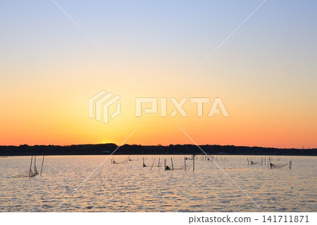 Morning glow reflected on the water surface Morning glow reflected on the water surface 141711871
