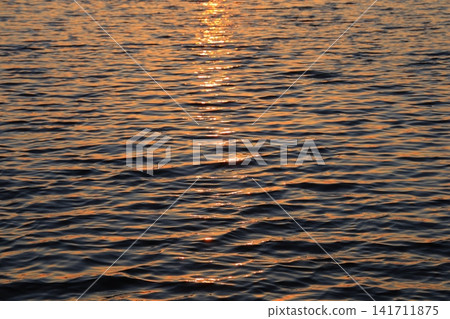 Morning glow reflected on the water surface Morning glow reflected on the water surface 141711875