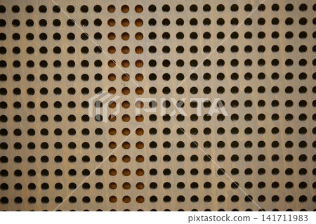 Perforated board on the wall of the music room Perforated board on the wall of the music room 141711983