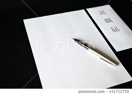 Image of a businessman preparing a resignation letter/notice of resignation. Image of a businessman preparing a resignation letter/notice of resignation. 141712730