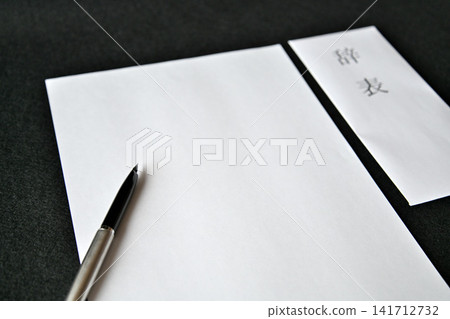 Image of a businessman preparing a resignation letter/notice of resignation. Image of a businessman preparing a resignation letter/notice of resignation. 141712732