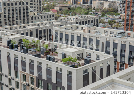 Rooftops of contemporary buildings showcase greenery and modern architecture Rooftops of contemporary buildings showcase greenery and modern architecture 141713304