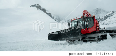 Snowplow works diligently to remove snow from mountain terrain Snowplow works diligently to remove snow from mountain terrain 141713324