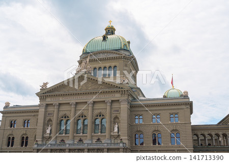 Curia Confoederationis Helveticae Latin phrase on Federal Palace Bundeshaus in Bern, Switzerland. Origin of Swiss country code CH, famous historical monument and parliament building facade Curia Confoederationis Helveticae Latin phrase on Federal Palace Bundeshaus in Bern, Switzerland. Origin of Swiss country code CH, famous historical monument and parliament building facade 141713390