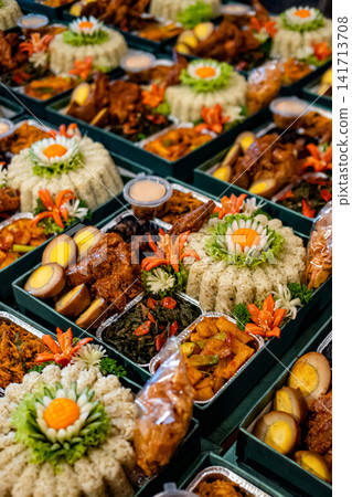 Multiple Indonesian meal boxes featuring nasi daun jeruk rice, eggs, vegetables, and traditional dishes. Ideal for catering, delivery, and Asian food concepts. Multiple Indonesian meal boxes featuring nasi daun jeruk rice, eggs, vegetables, and traditional dishes. Ideal for catering, delivery, and Asian food concepts. 141713708