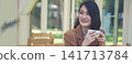 Banner hands of woman sitting office desk holding sweet coffee cup relax and enjoy with happy time. Panorama Hot coffee mug. Woman holding coffee cup relaxing after work at office in cafe copy space 141713784