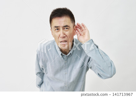A man who is hard of hearing on a white background A man who is hard of hearing on a white background 141713967