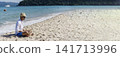 Banner Man traveler use laptop on summer beach blue sky. Asian man travel relax sitting summer beach island. Man typing laptop computer holiday business trip freelance working online with copy space 141713996
