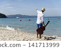 Young men playing acoustic guitar on the beach. Happy man person playing acoustic guitar music instrument seaside sitting on sand tropical beach island. Asian musician Happy guitarist hobby lifestyle 141713999