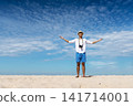 Man traveler using digital camera on summer beach blue sky take a photo. Asian Photographer man journey relax on the beach in summertime. Man backpack shooting photo asia destination holiday trip 141714001