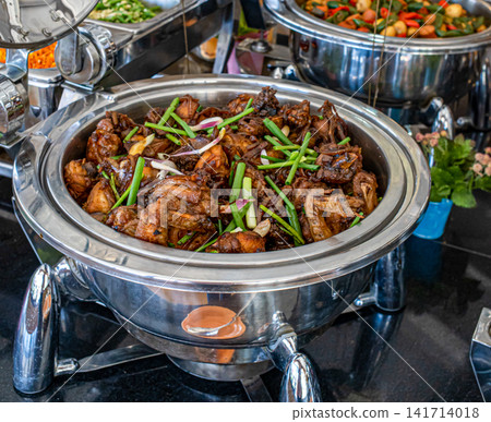 Traditional Indonesian butter fried chicken coated with rich soy butter sauce and served buffet style. Asian comfort food for hospitality, catering, restaurant and menu concepts. Traditional Indonesian butter fried chicken coated with rich soy butter sauce and served buffet style. Asian comfort food for hospitality, catering, restaurant and menu concepts. 141714018