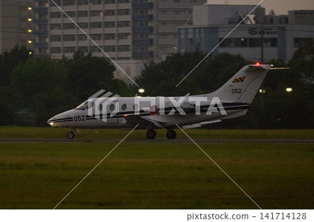 A Japan Air Self-Defense Force T-400 trainer aircraft lands at dusk. A Japan Air Self-Defense Force T-400 trainer aircraft lands at dusk. 141714128