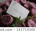 A birthday card attached to a bouquet of roses A birthday card attached to a bouquet of roses 141714300