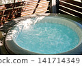 Inflatable Hot Tub with Bubbling Water on Outdoor Terrace 141714349