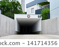 Underground parking garage entrance with height restriction sign 141714356