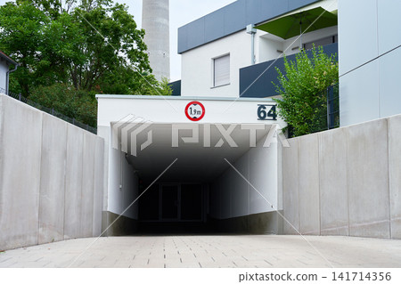 Underground parking garage entrance with height restriction sign Underground parking garage entrance with height restriction sign 141714356