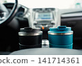 Reusable cups placed in car cup holders 141714361
