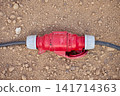 Industrial power cable connector lying on the ground 141714363