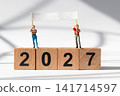 Miniature People Holding Blank Banner on Wooden 2027 Blocks with Copy Space 141714597
