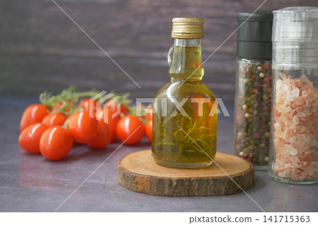 Tomato, oil, and spices on a wooden surface Tomato, oil, and spices on a wooden surface 141715363