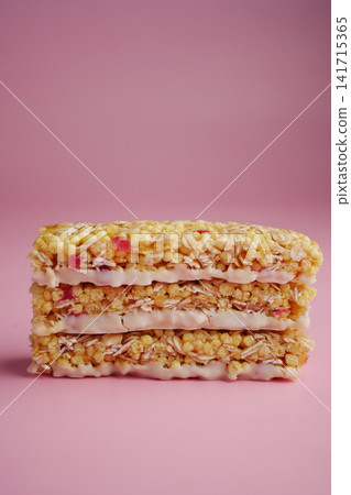 Colorful layered treat on a pink background Colorful layered treat on a pink background 141715365