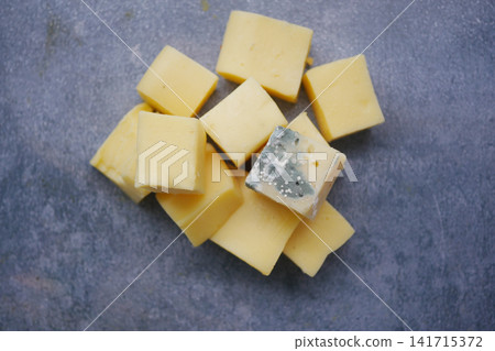mold cheese cubes placed on a gray surface in a kitchen mold cheese cubes placed on a gray surface in a kitchen 141715372