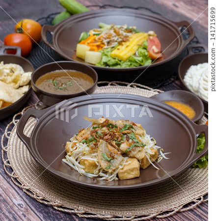Tahu gimbal Indonesian traditional dish with tofu shrimp fritters bean sprouts and peanut sauce Asian street food cuisine Tahu gimbal Indonesian traditional dish with tofu shrimp fritters bean sprouts and peanut sauce Asian street food cuisine 141715699