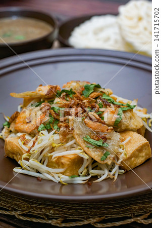 Tahu gimbal Indonesian traditional dish with tofu shrimp fritters bean sprouts and peanut sauce Asian street food cuisine Tahu gimbal Indonesian traditional dish with tofu shrimp fritters bean sprouts and peanut sauce Asian street food cuisine 141715702