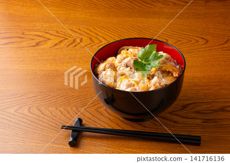 Oyakodon topped with mitsuba (Japanese parsley) Oyakodon topped with mitsuba (Japanese parsley) 141716136