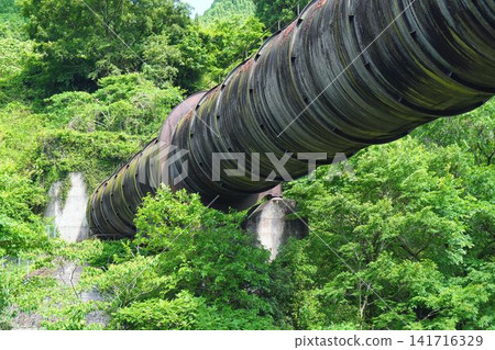 A giant pipe disappears into the mountains A giant pipe disappears into the mountains 141716329