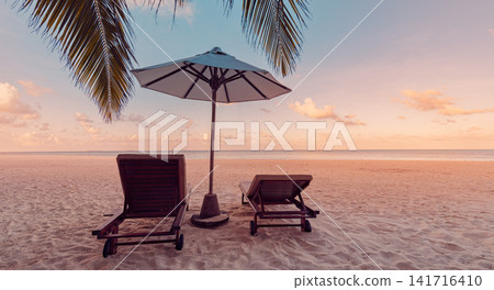 Dreamy beach loungers under palm-fringed umbrella at soft sunset beside turquoise sea powder-white sand. Perfect summer vacation travel landscape paradise. Luxury honeymoon getaway relax scenic Dreamy beach loungers under palm-fringed umbrella at soft sunset beside turquoise sea powder-white sand. Perfect summer vacation travel landscape paradise. Luxury honeymoon getaway relax scenic 141716410
