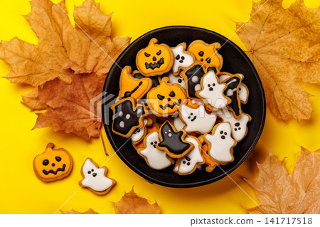 Halloween gingerbread cookies on bright yellow background 141717518