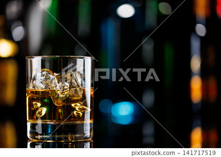 Whiskey on the rocks on a bar table Whiskey on the rocks on a bar table 141717519