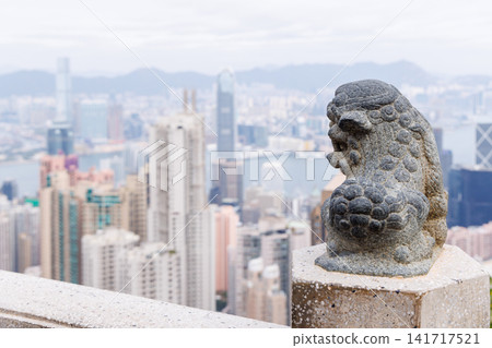 Hong Kong - Victoria Harbour skyline view of the city from hill with green plants in foreground Hong Kong - Victoria Harbour skyline view of the city from hill with green plants in foreground 141717521
