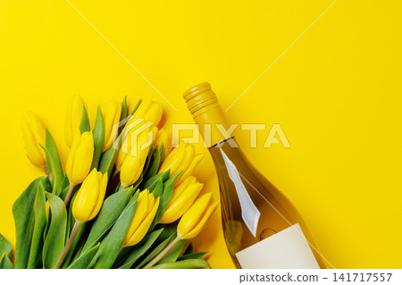 White wine bottle with yellow tulips 141717557