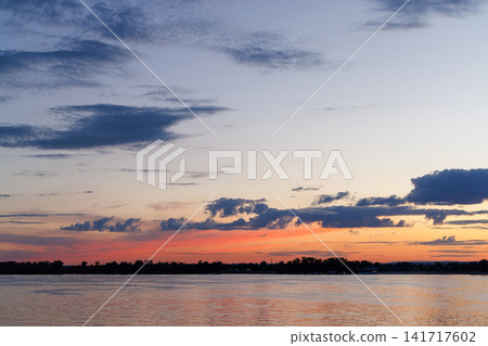 Dramatic twilight sky over river horizon 141717602