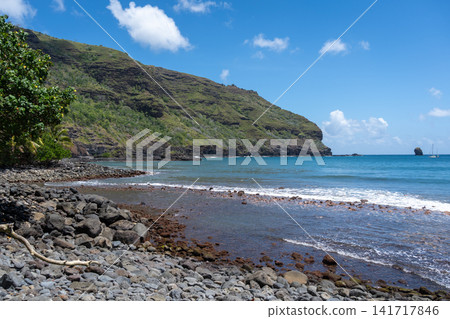 Rocky beach with blue waters in Hiva Oa, Marquesas Islands, French Polynesia Rocky beach with blue waters in Hiva Oa, Marquesas Islands, French Polynesia 141717846