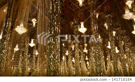 Ornate Golden Mirror Hall Decorated with Crystal Chandeliers in Thai Temple Ornate Golden Mirror Hall Decorated with Crystal Chandeliers in Thai Temple 141718184