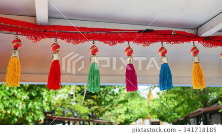 Colorful Decorative Hanging Tassels Garland Attached to Roof Line Colorful Decorative Hanging Tassels Garland Attached to Roof Line 141718185