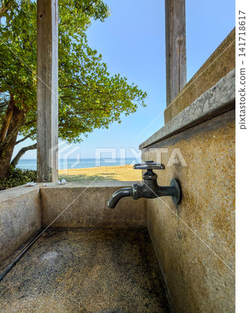 A retro water tap overlooking the sea and a summer scene A retro water tap overlooking the sea and a summer scene 141718617