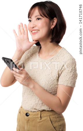Asian woman waving while holding smartphone with cheerful expression isolated transparent background for friendly 141718746