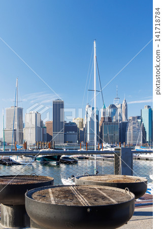 An empty outdoor barbecue grill set against a blurred view of the Manhattan skyline An empty outdoor barbecue grill set against a blurred view of the Manhattan skyline 141718784