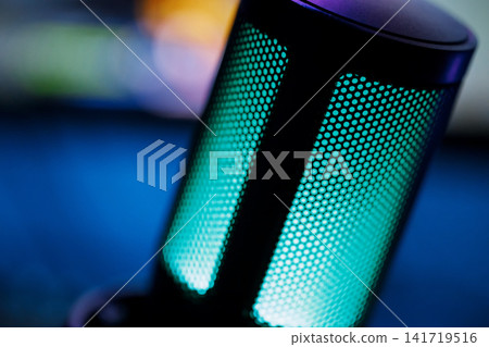 Dark cinematic macro of streamer mic on desk with RGB accent lighting Dark cinematic macro of streamer mic on desk with RGB accent lighting 141719516