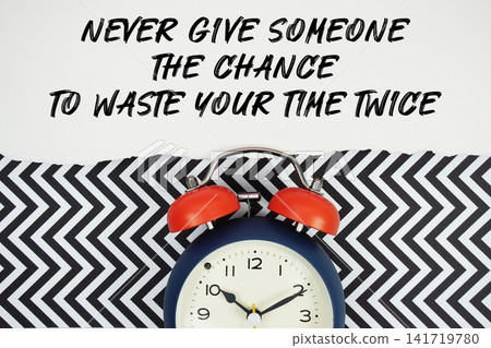 Never Give Someone The Chance To Waste Your Time Twice text written on paper with alarm clock on black chevron background Never Give Someone The Chance To Waste Your Time Twice text written on paper with alarm clock on black chevron background 141719780