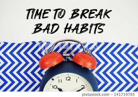 Time To Break Bad Habits text written on paper with alarm clock on blue chevron background Time To Break Bad Habits text written on paper with alarm clock on blue chevron background 141719785
